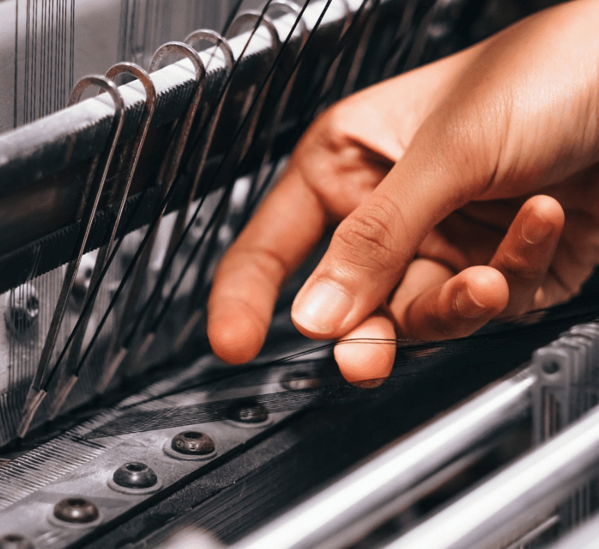 Person weaving fabric.