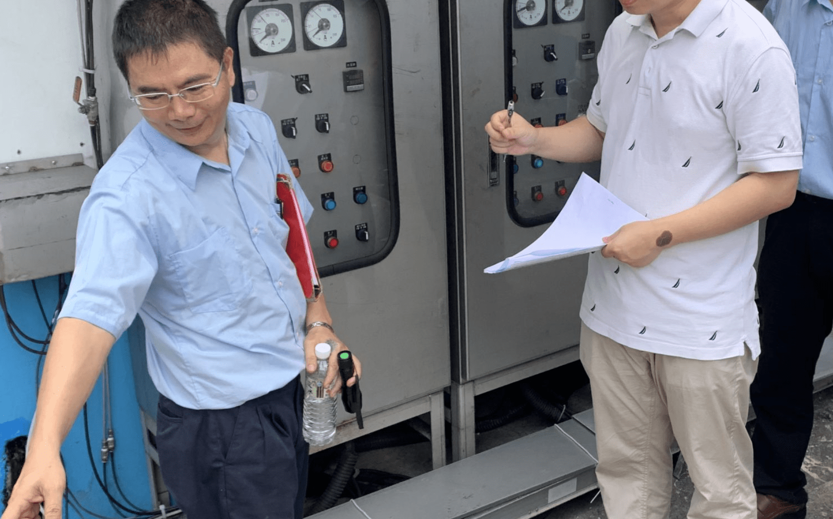 Two people looking at machinery